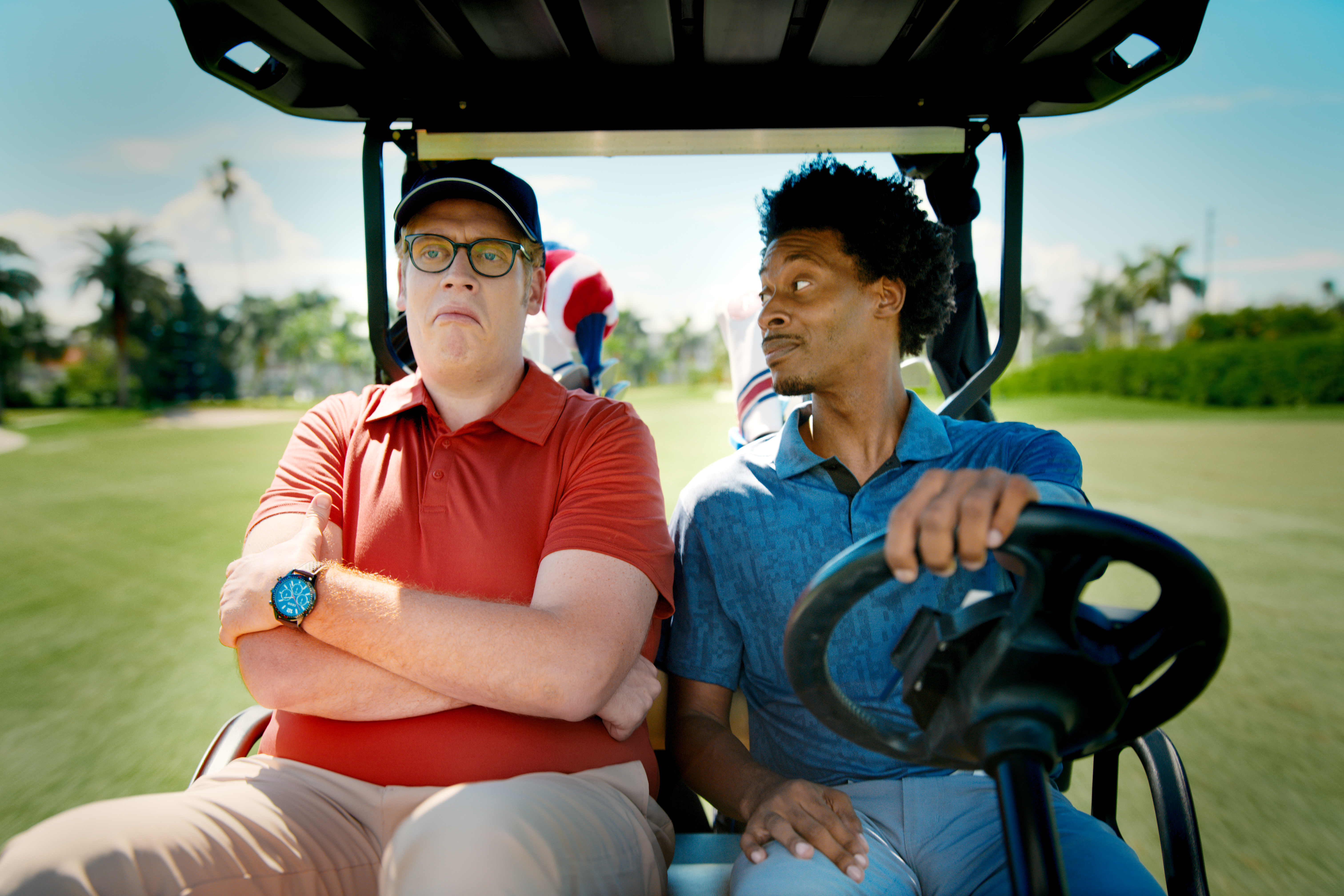 AAA two people in a golf cart.