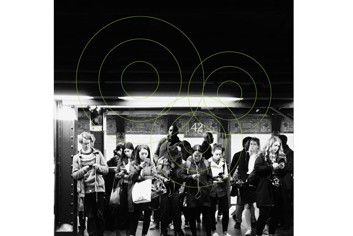 Image showing people on a subway platform using their smart phones and tablets.
